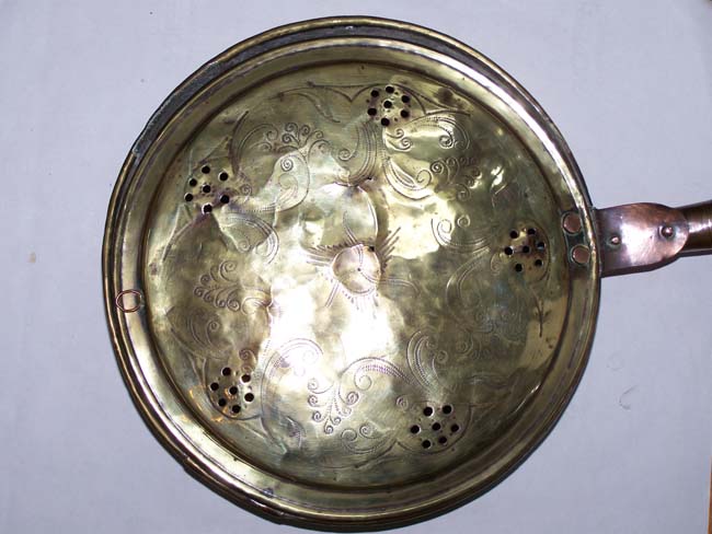 An English Engraved Brass Bed Warming Pan with turned Fruitwood Handle circa 1780.